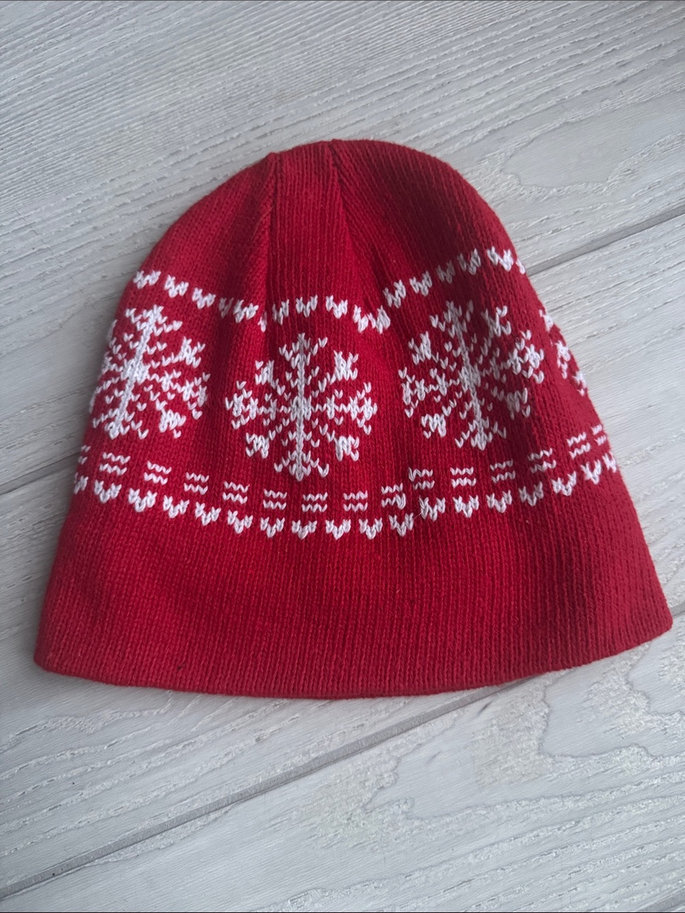 red Juncture beanie features a white Fair Isle snowflake pattern fleece lined